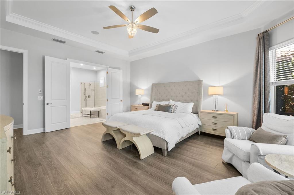 15345 Aprile Street Naples, FL 34114 - Photo 16 of 29 a spacious bedroom with a bed couch and window