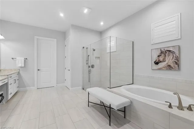 a spacious bathroom with a bathtub and a shower