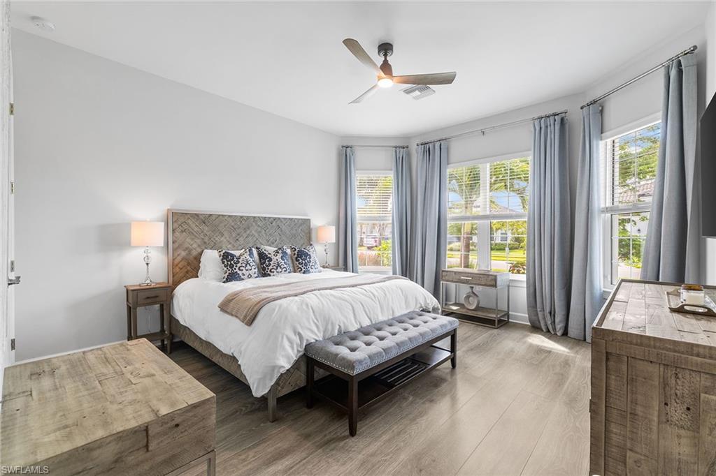 15345 Aprile Street Naples, FL 34114 - Photo 21 of 29 a bed sitting in a spacious bedroom next to a window