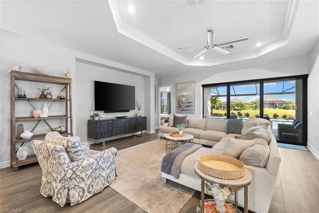 15345 Aprile Street Naples, FL 34114 - Photo 3 of 29 a living room with furniture and a flat screen tv