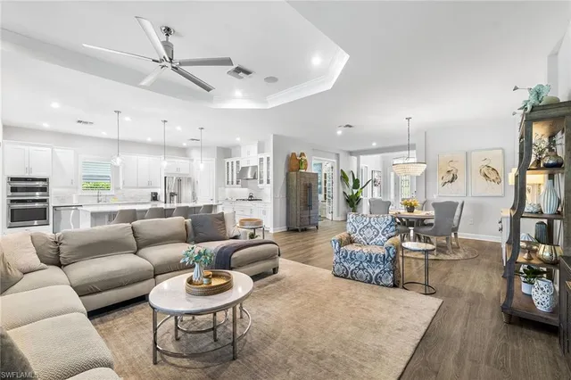 a living room with furniture and a view of kitchen