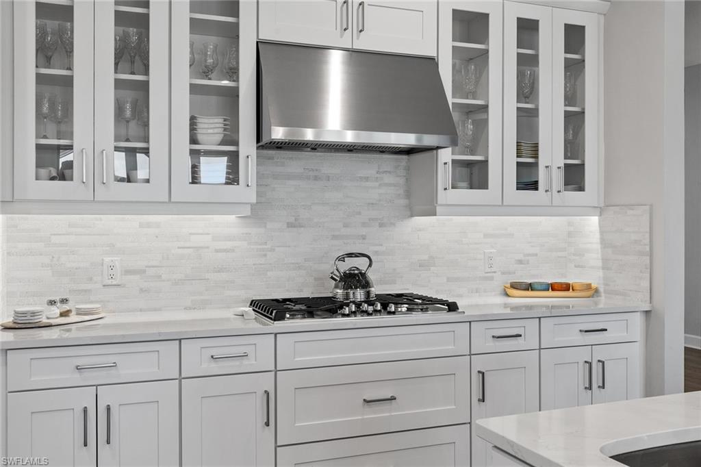 15345 Aprile Street Naples, FL 34114 - Photo 7 of 29 a kitchen with a sink and cabinets