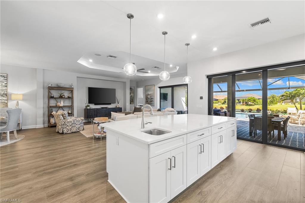 15345 Aprile Street Naples, FL 34114 - Photo 9 of 29 a large white kitchen with a large window