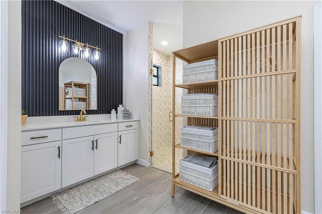 20278 Kingmont Drive Estero, FL 33928 - Photo 21 of 38 Bathroom featuring baseboards, vanity, and wood finished floors