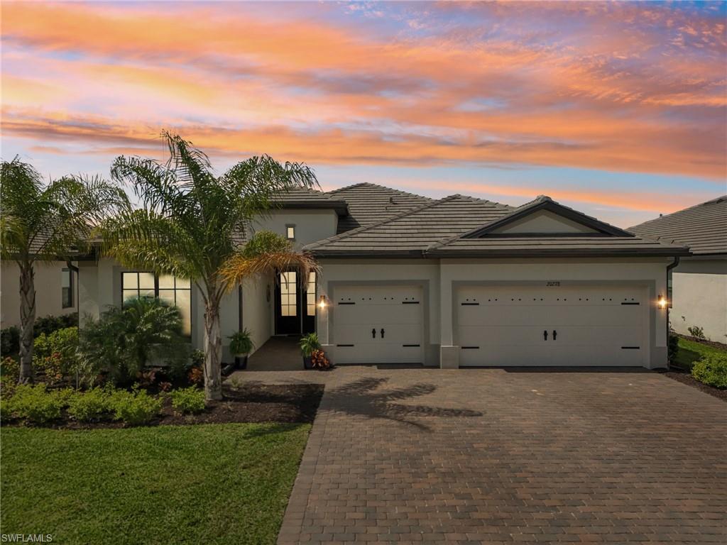 20278 Kingmont Drive Estero, FL 33928 - Photo 3 of 38 View of front of house featuring a tiled roof, decorative driveway, an attached garage, and stucco siding