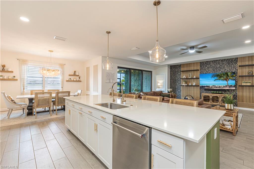 20278 Kingmont Drive Estero, FL 33928 - Photo 9 of 38 Kitchen featuring plenty of natural light, light countertops, a kitchen island with sink, dishwasher, and a sink