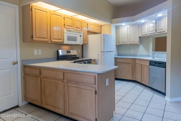 a kitchen with stainless steel appliances granite countertop a sink and a stove
