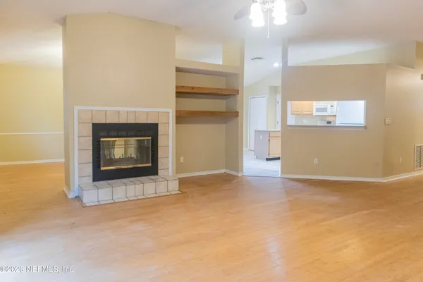 a view of an empty room with a fireplace