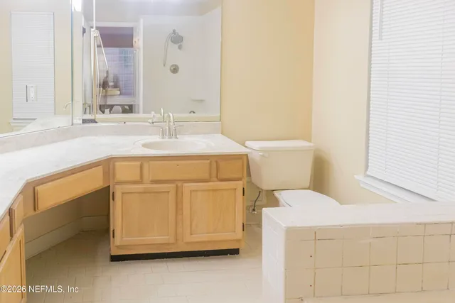 a bathroom with a sink a toilet and vanity