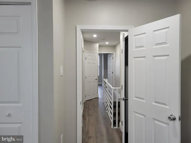 a view of a hallway with the wooden floor and a hallway