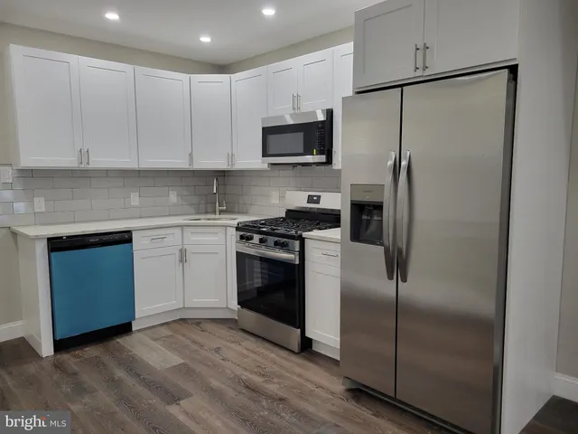 a kitchen with a refrigerator stove and microwave