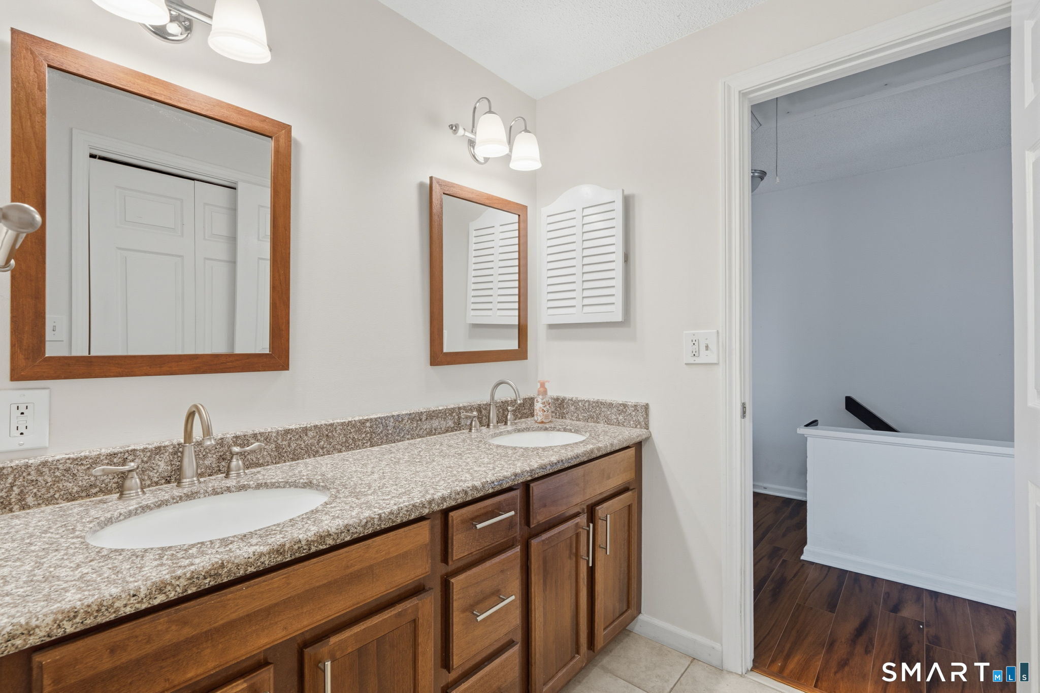 73 Metacomet Drive, Unit 73 Meriden, CT 06450 - Photo 23 of 37 a bathroom with a granite countertop sink and a mirror