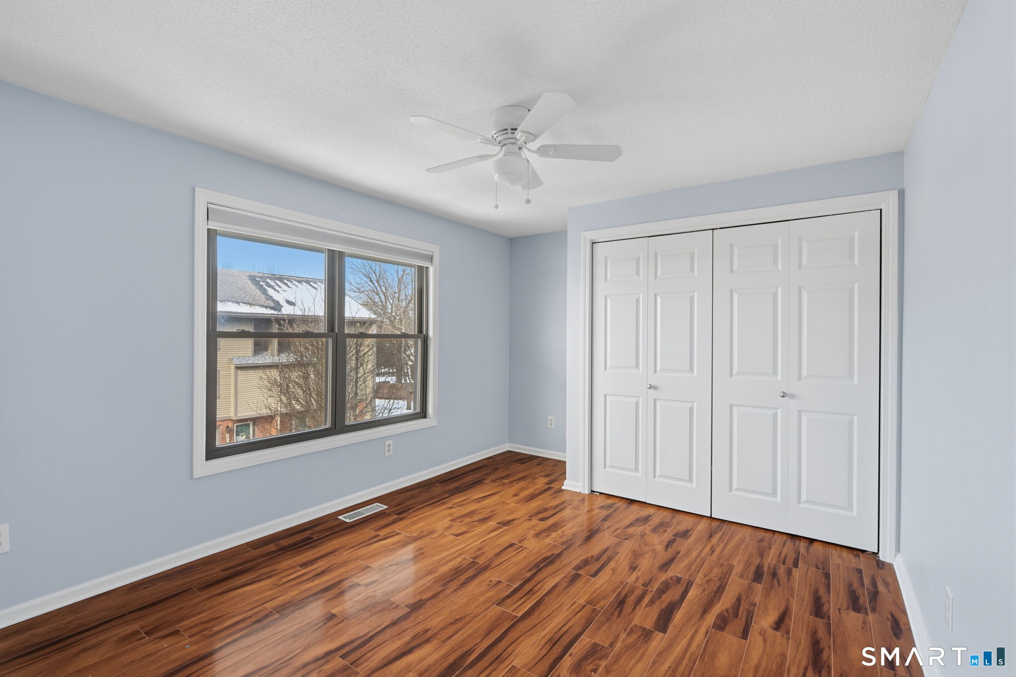 73 Metacomet Drive, Unit 73 Meriden, CT 06450 - Photo 24 of 37 a view of an empty room with a window and wooden floor