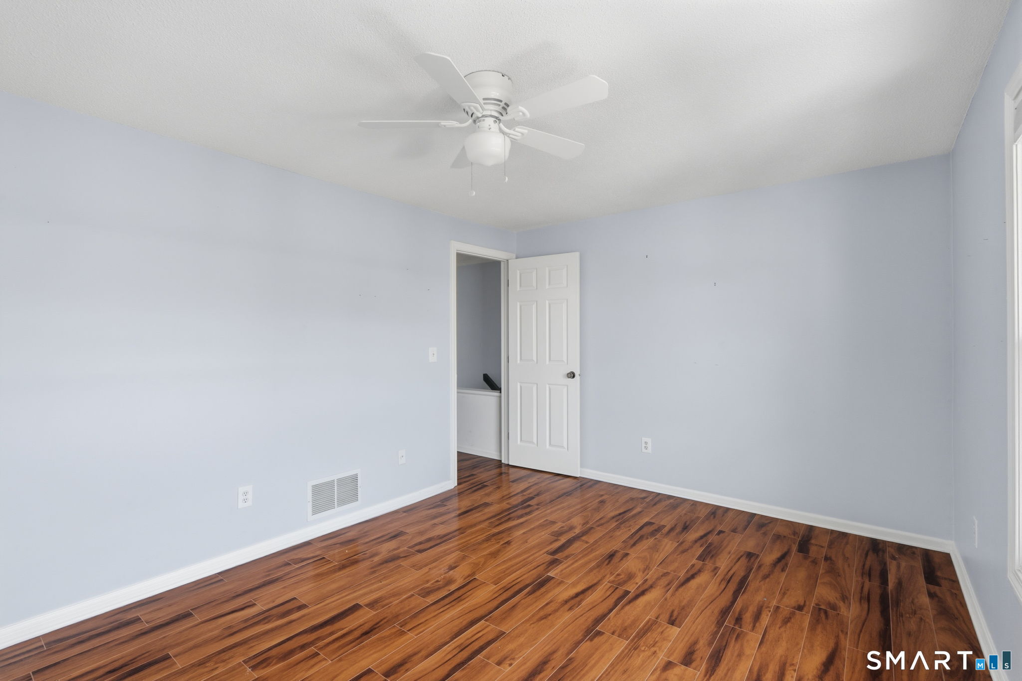 73 Metacomet Drive, Unit 73 Meriden, CT 06450 - Photo 25 of 37 a view of an empty room with wooden floor