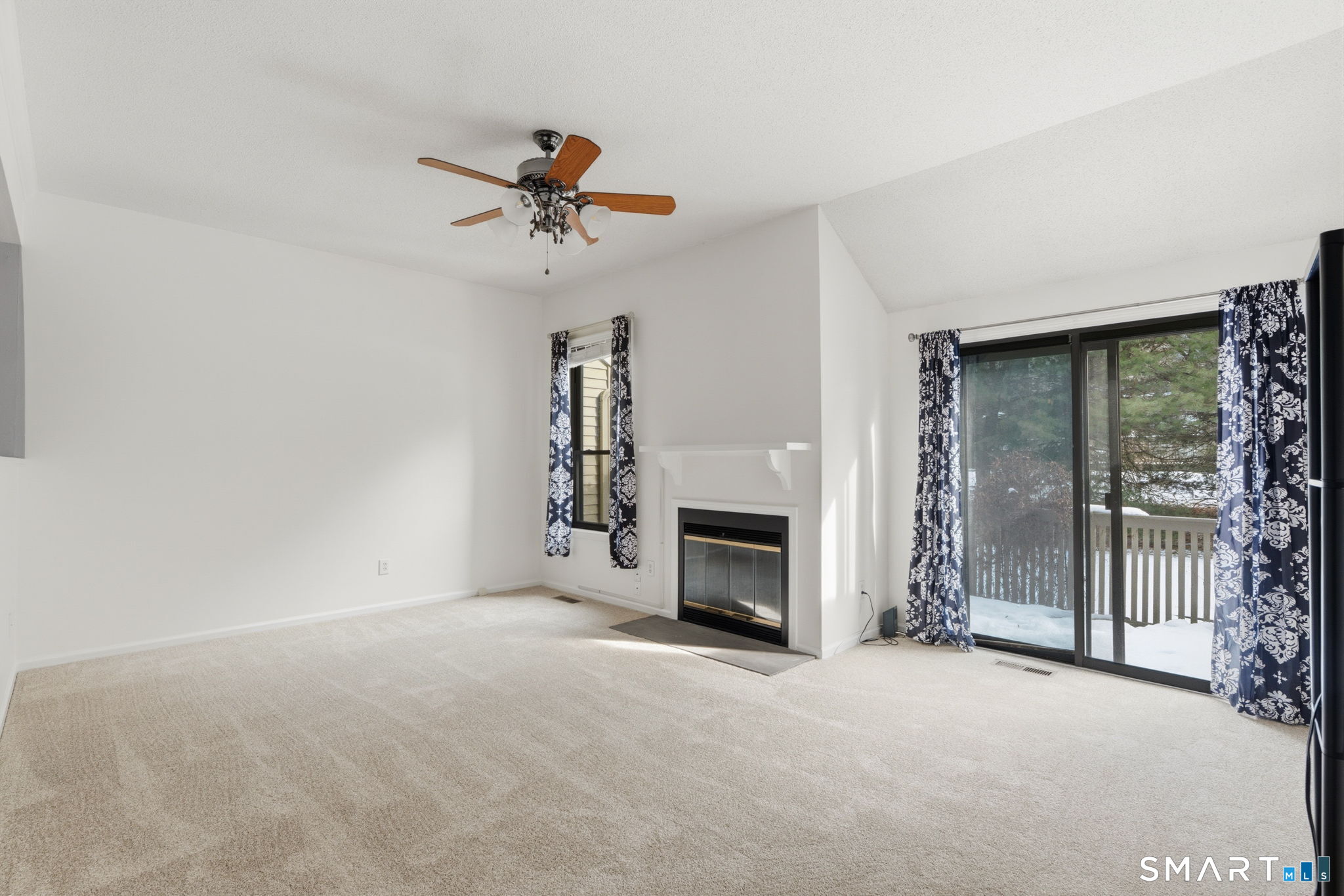 73 Metacomet Drive, Unit 73 Meriden, CT 06450 - Photo 5 of 37 a view of empty room with fireplace and fan