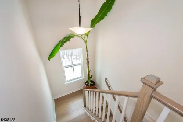 a view of entryway with window and wooden floor