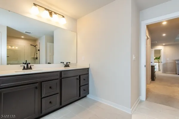 a bathroom with a double vanity sink and a mirror
