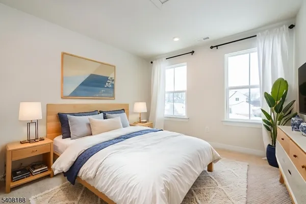 a bedroom with bed and a window