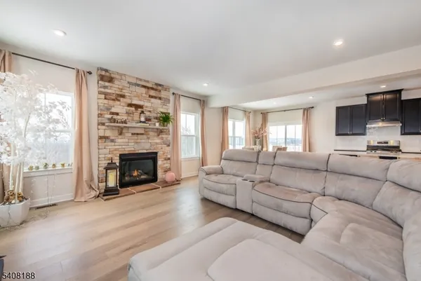 a kitchen with stainless steel appliances kitchen island granite countertop a stove refrigerator and cabinets