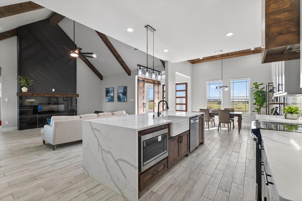 a kitchen with counter top space and wooden floor
