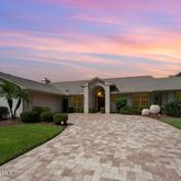 a front view of a house with a yard and potted plants
