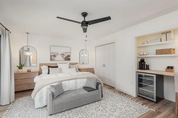 a bedroom with a bed and ceiling fan