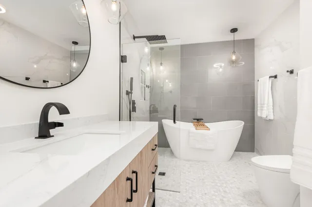 a bathroom with a sink a toilet and a mirror