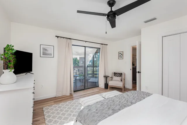 a bedroom with a bed and flat screen tv