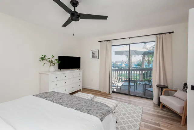 a bedroom with a bed and large window