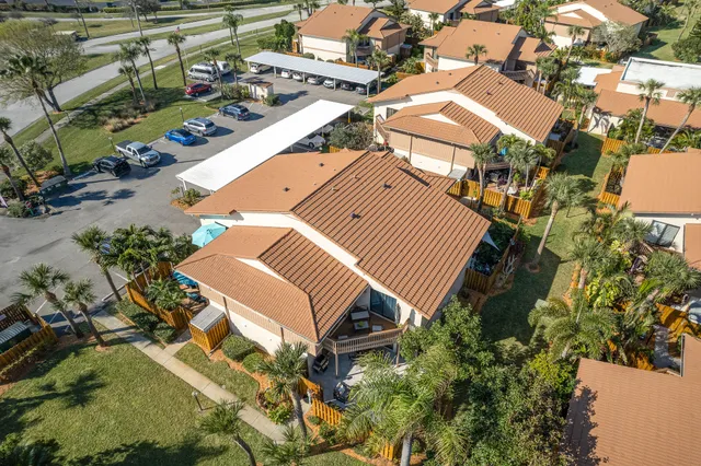 an aerial view of a house with a yard and parking