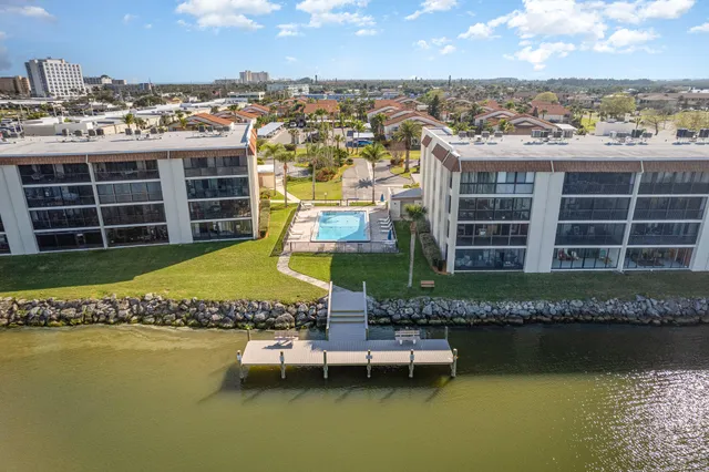 a view of a swimming pool with outdoor seating and a yard