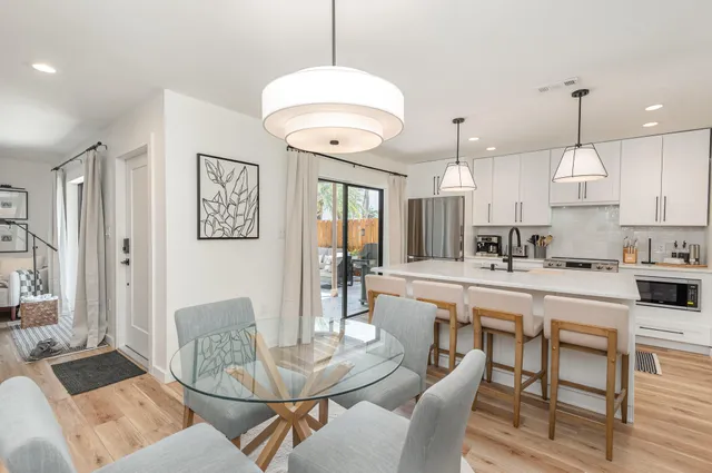 a large kitchen with a table and chairs