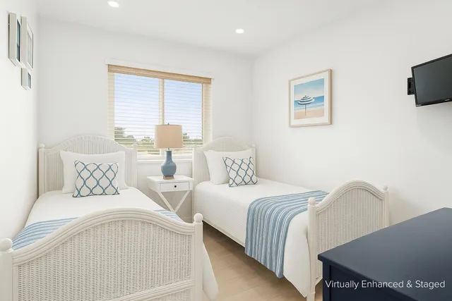 a kitchen with white cabinets and appliances
