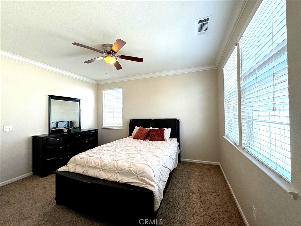 154 Montage Drive Merced, CA 95348 - Photo 8 of 18 a bedroom with a bed and a dresser next to a window