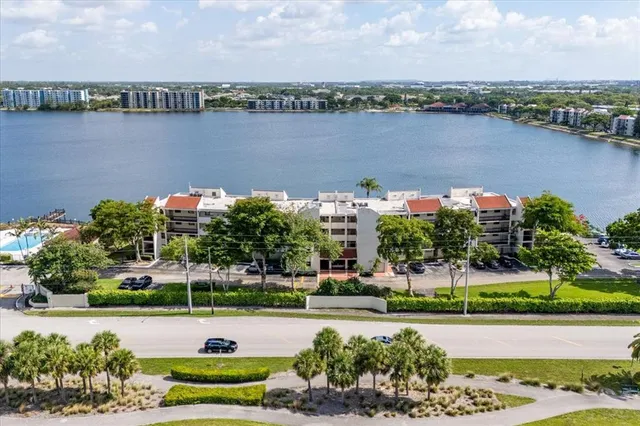 an aerial view of a house with a yard and lake view