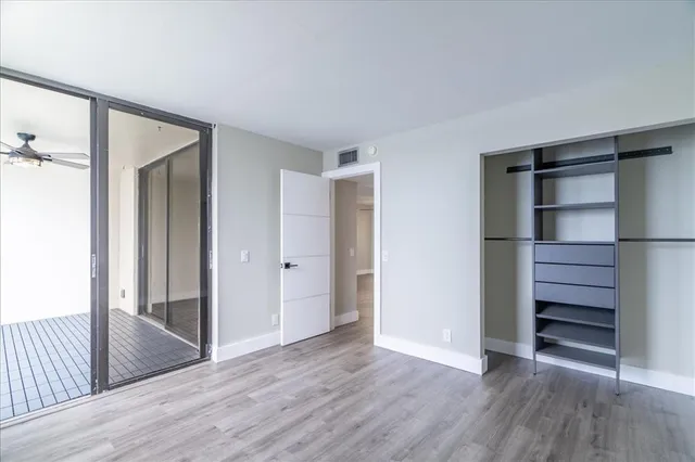 a view of walk in closet with empty racks