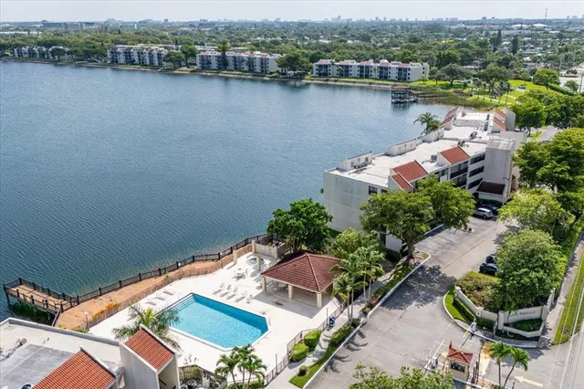 an aerial view of a house with outdoor space and lake view