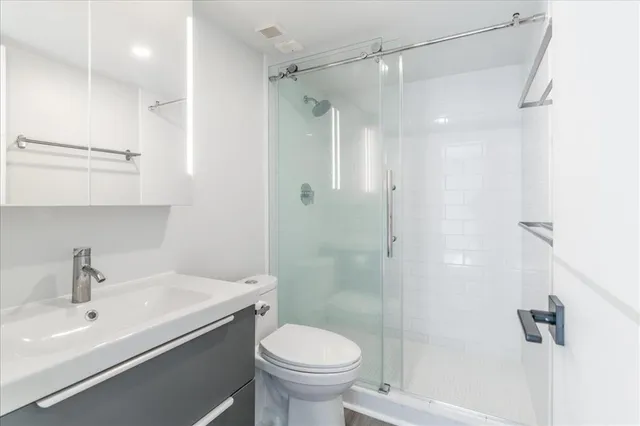 a bathroom with a sink toilet and shower