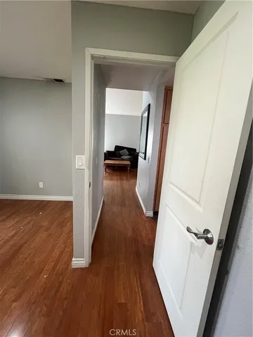 a view of a hallway view with wooden floor and staircase
