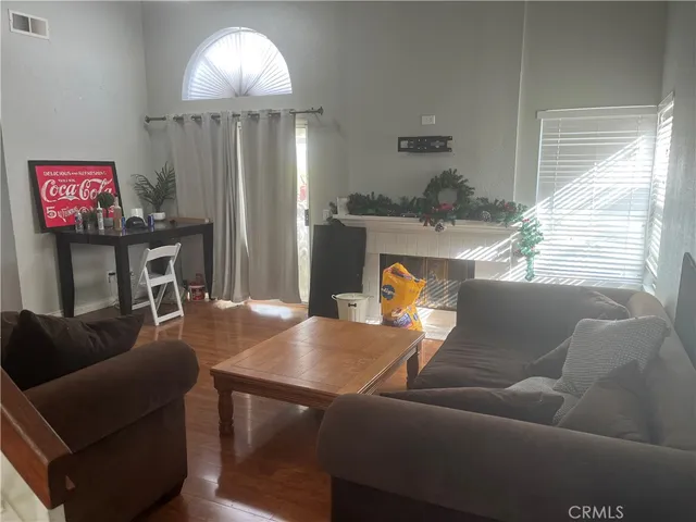 a living room with furniture a flat screen tv and a window
