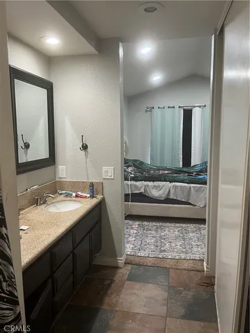 a bathroom with a sink a vanity and a mirror