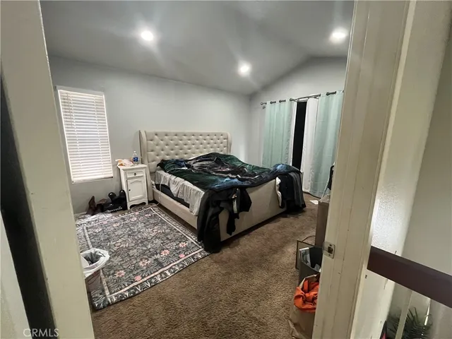 a bedroom with a bed and a mirror