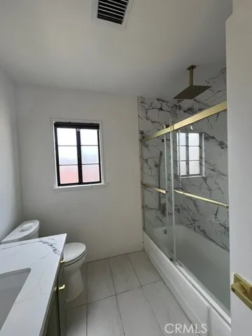 a bathroom with a toilet a sink and shower