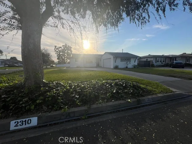 a view of a yard with wooden fence