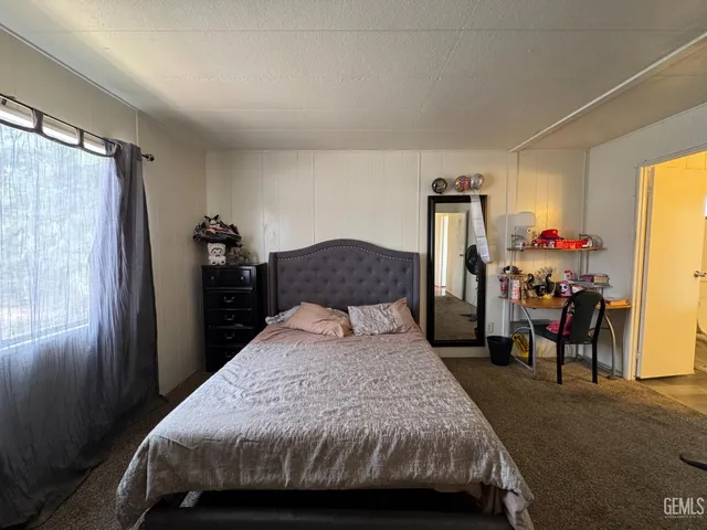 a bedroom with a bed and a table