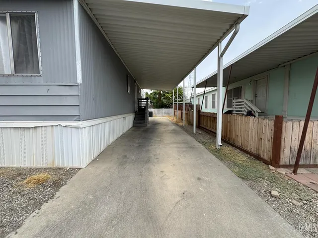 a view of a house with wooden fence