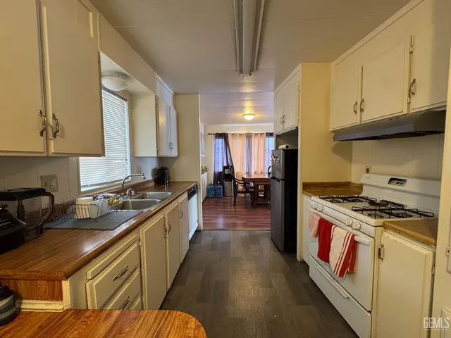 a kitchen with a stove a sink and a refrigerator