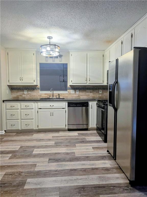 108 Riley Way Canton, GA 30115 - Photo 10 of 33 a kitchen with stainless steel appliances granite countertop a refrigerator sink and cabinets