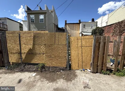 a view of a house with a wooden fence