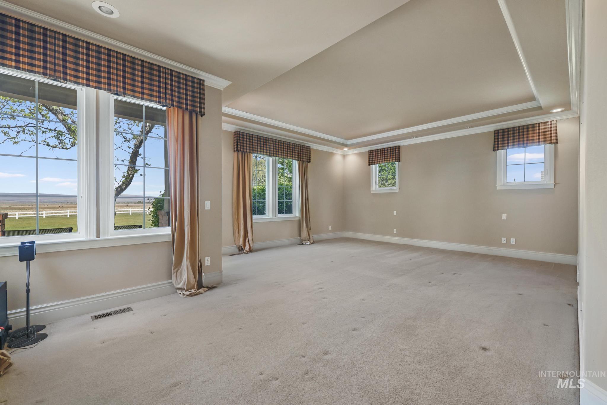 1526 Highway 26 Gooding, ID 83330 - Photo 5 of 48 Carpeted empty room with a raised ceiling and ornamental molding